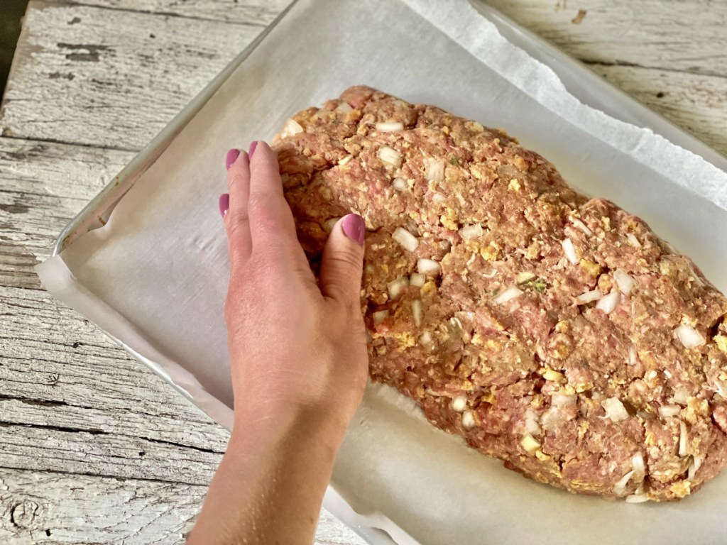 forming classic keto meatloaf on a baking sheet