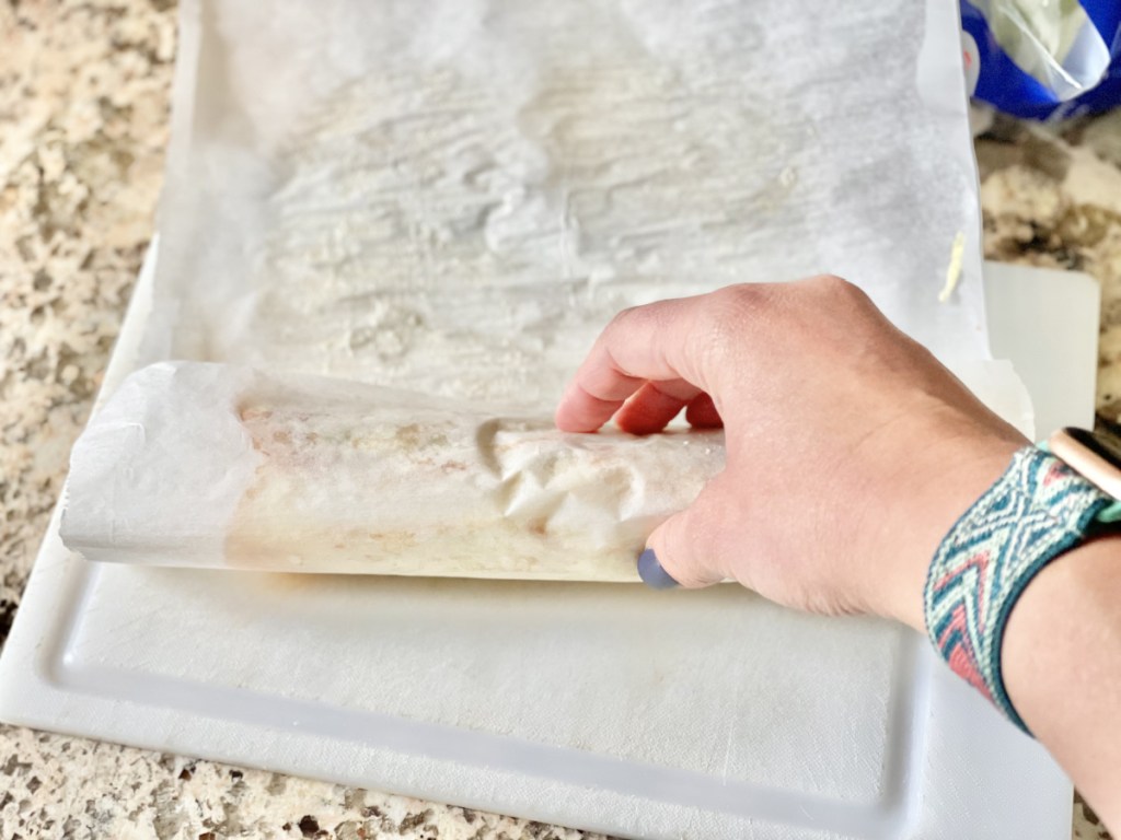 rolling up Keto Cheese Wrap in parchment