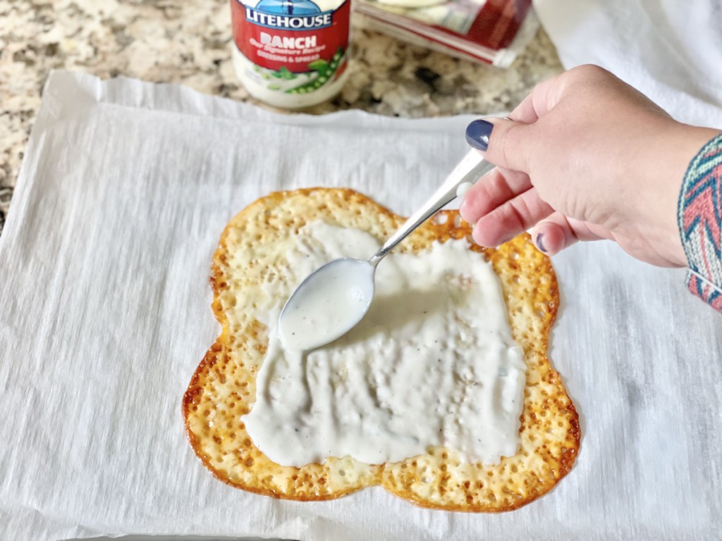 spreading ranch on Keto Cheese Wrap