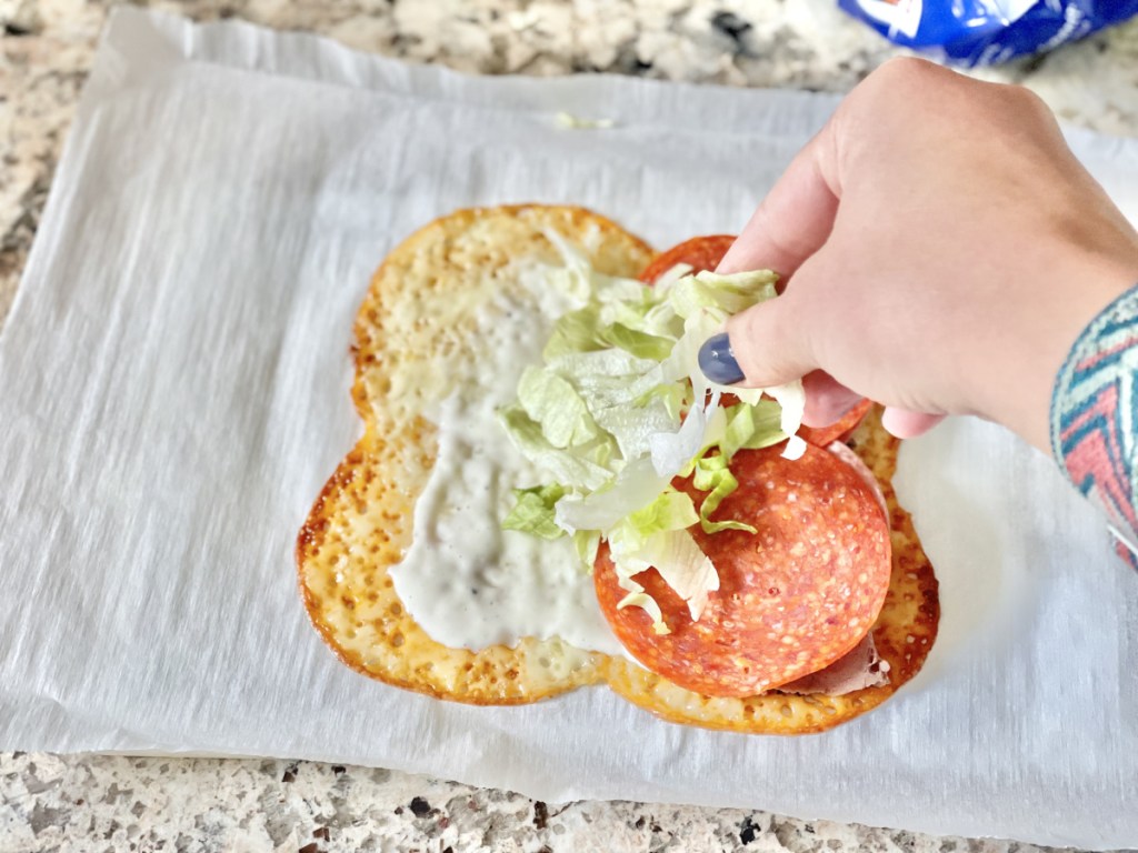 adding shredded lettuce to Keto Cheese Wrap