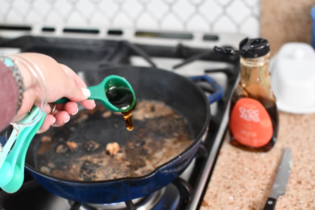 adding choczero maple syrup to skillet for Keto Maple Pork Tenderloins 