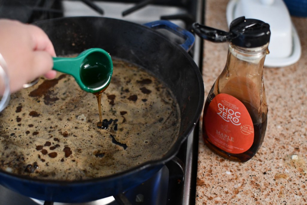 adding choczero maple syrup to skillet for Keto Maple Pork Tenderloins 