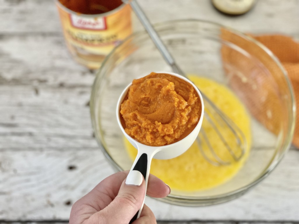 adding pumpkin to a bowl for keto pumpkin bread