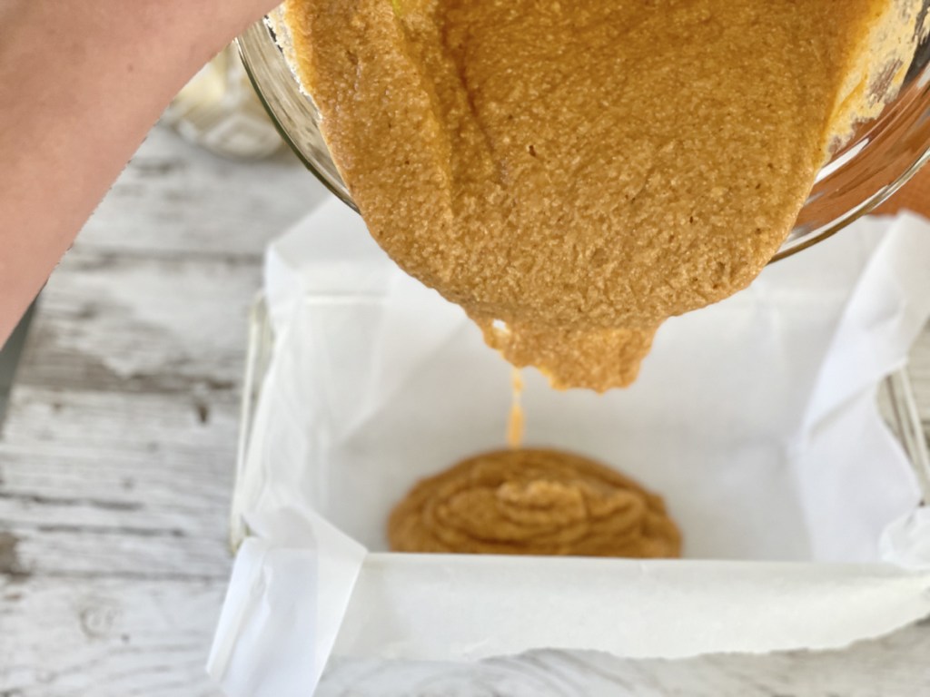 pouring batter into pan for keto pumpkin bread