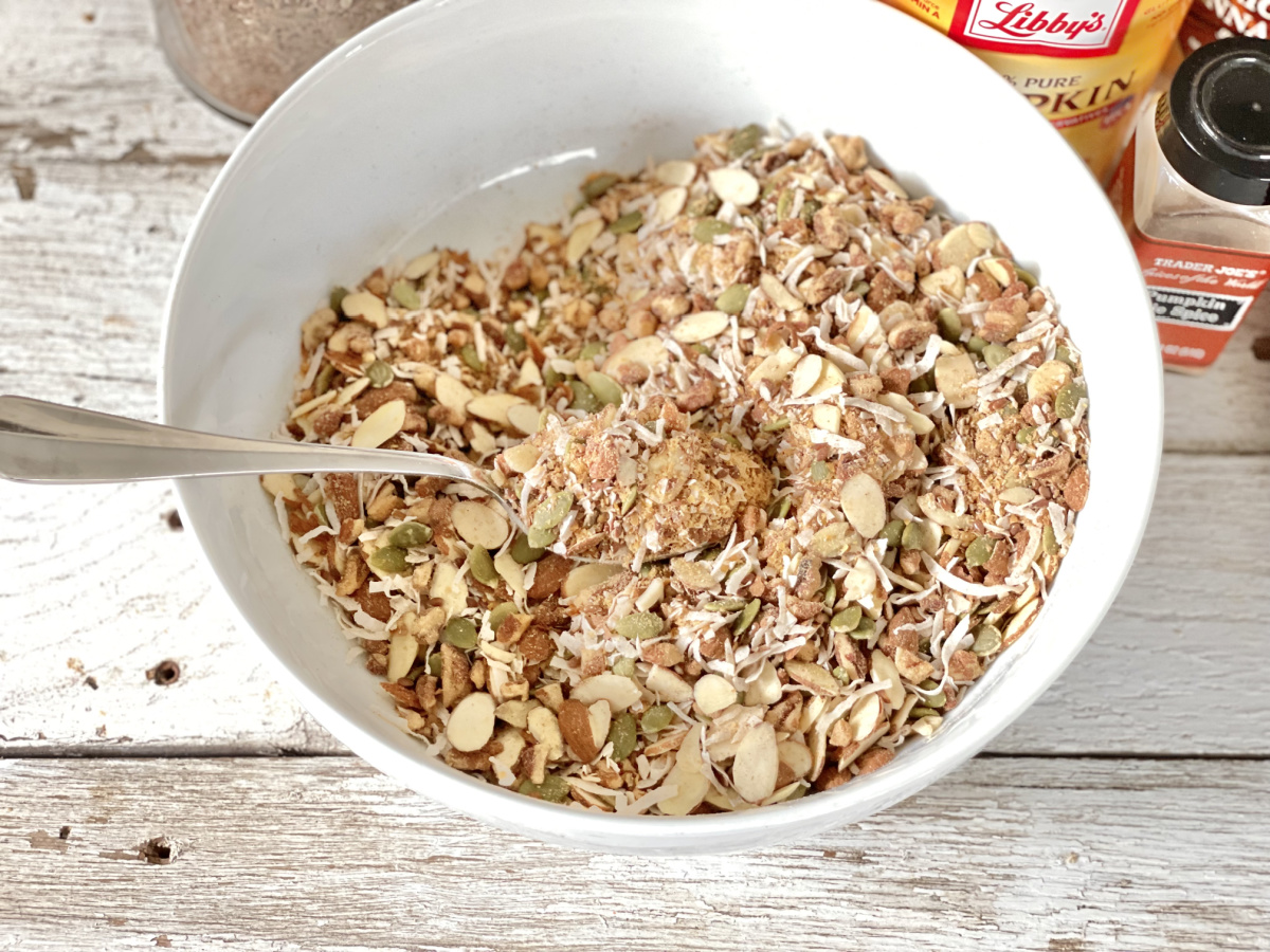 bowl with nuts, seeds, coconut, spices all mixed up 