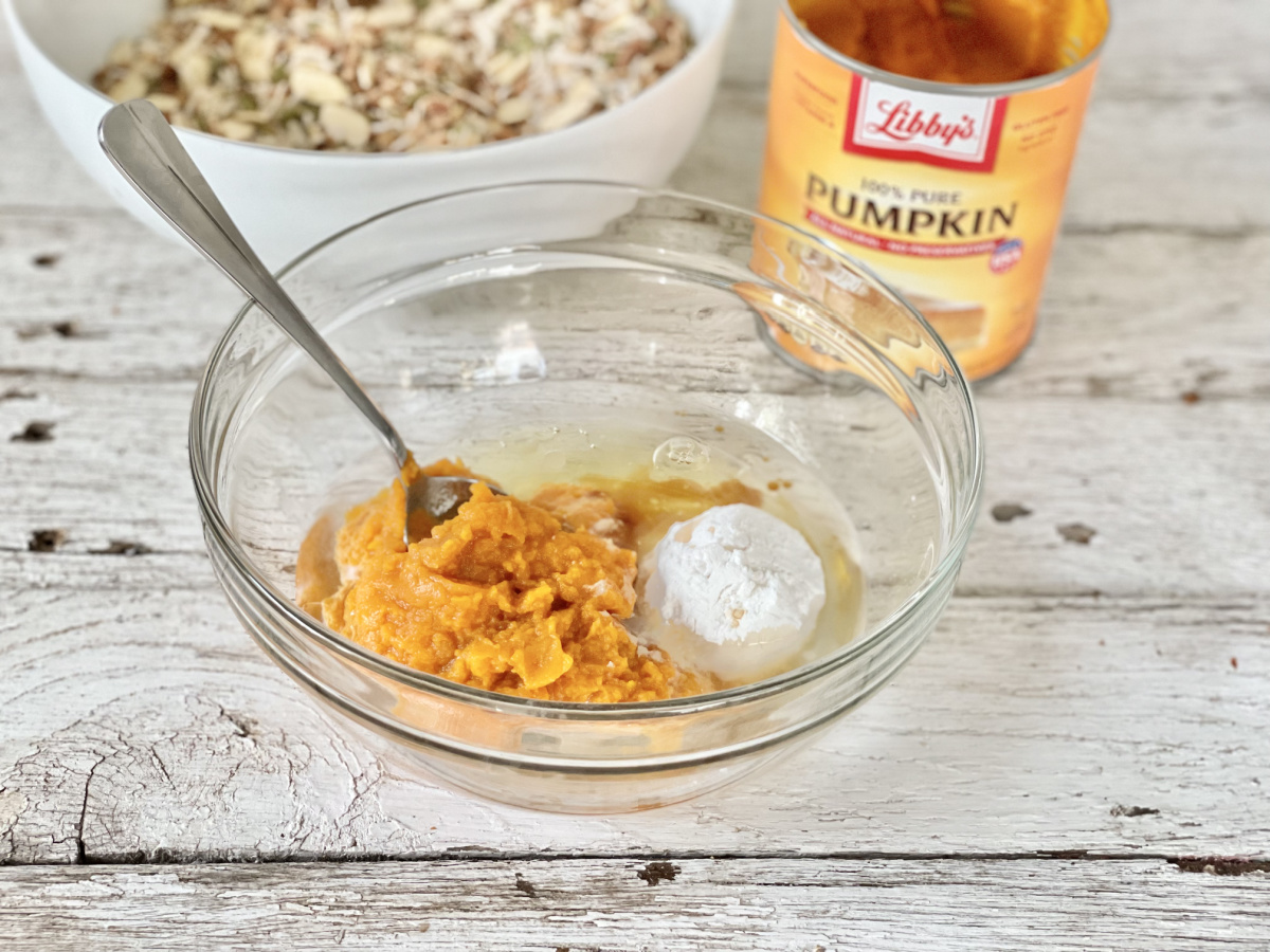 canned pumpkin with egg whites, vanilla, keto sweetener in a bowl