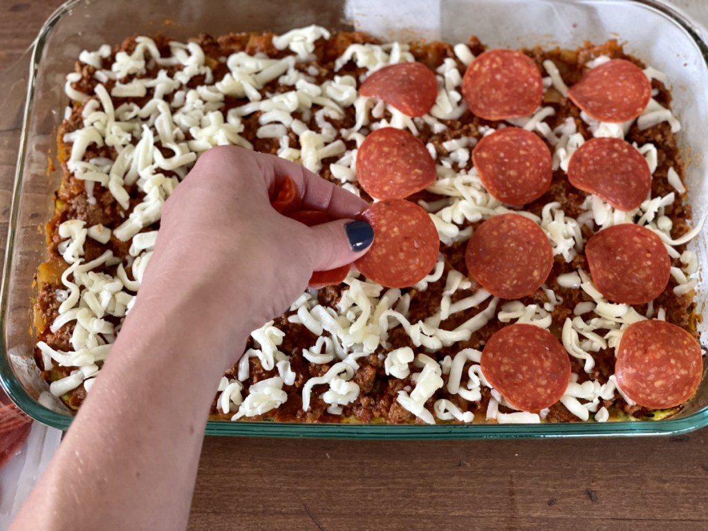 adding pepperoni to keto zucchini pizza casserole