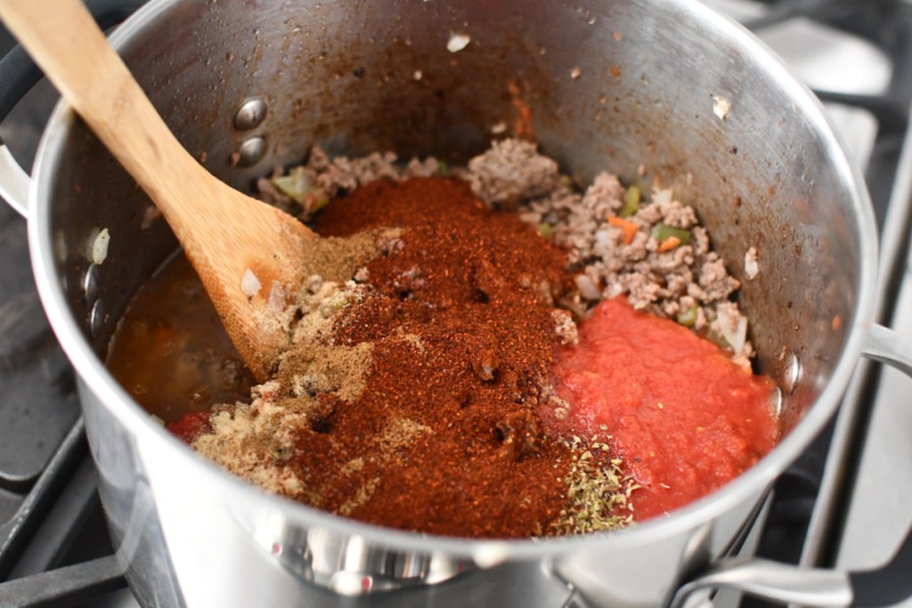 adding spices to keto chili on the stove