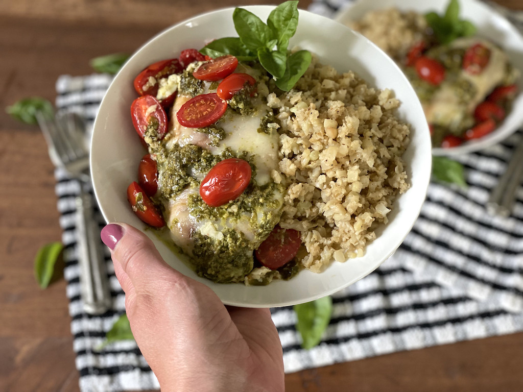 chicken in bowl with pesto, tomatoes, with cauliflower rice 