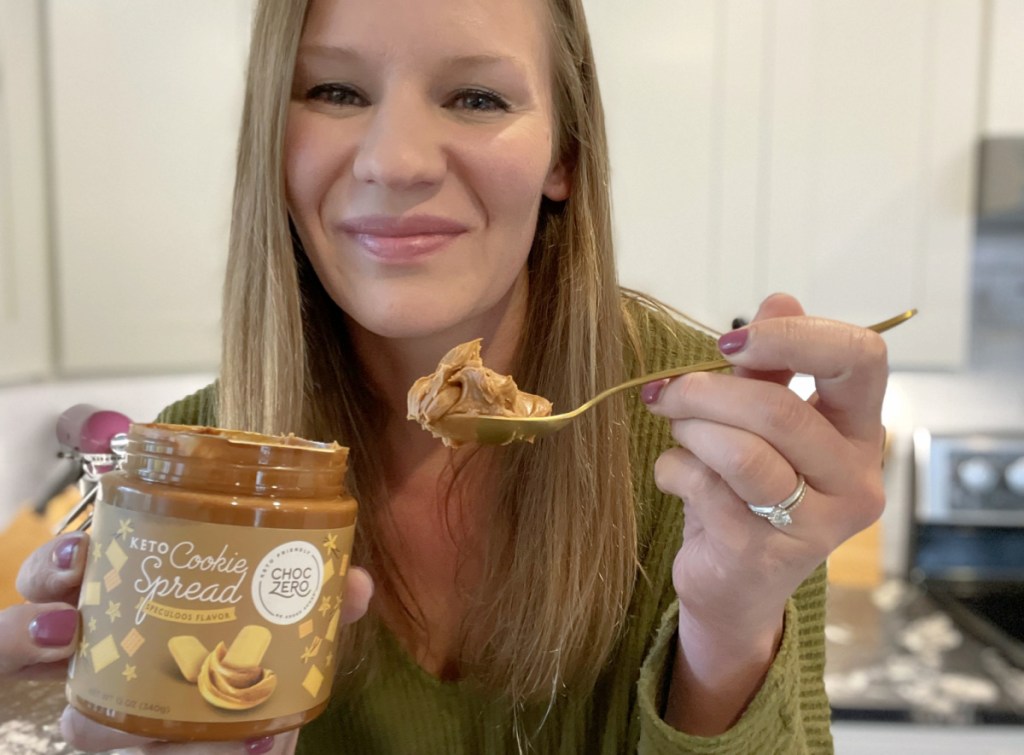 woman with spoonful of choczero keto cookie spread