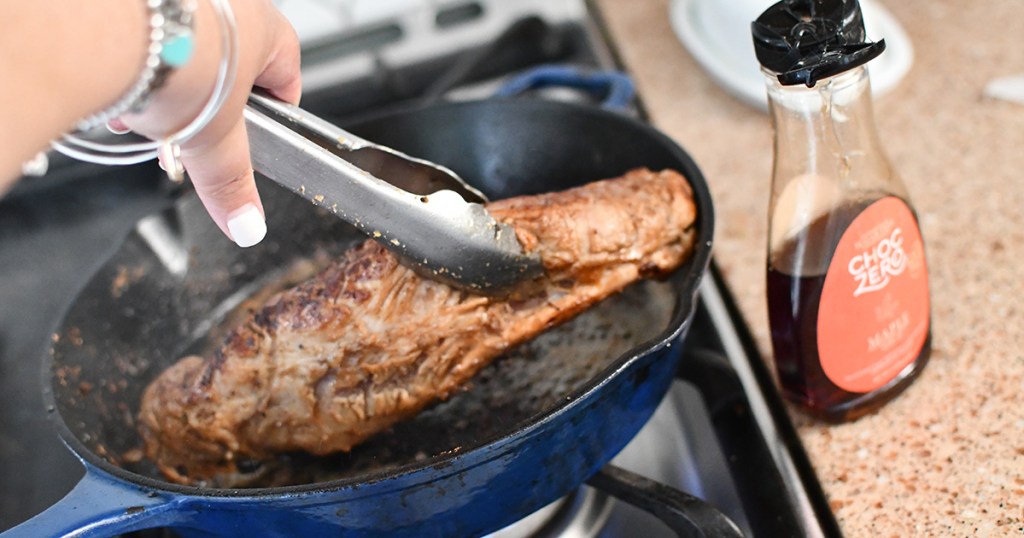 searing pork tenderloin with maple syrup in cast iron pan