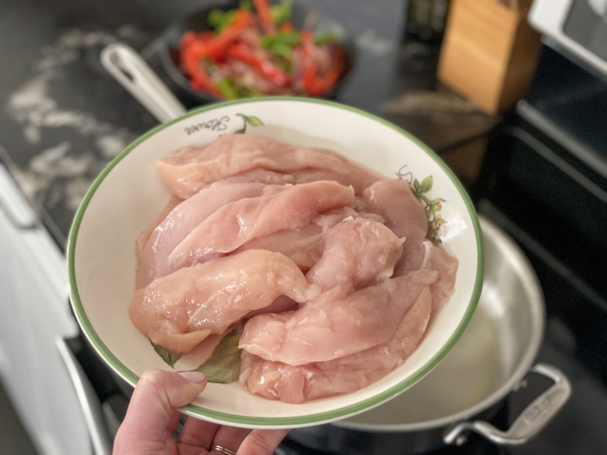 getting ready to pan cook raw chicken tenders