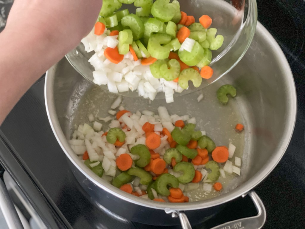adding veggies to pan for Keto Chicken Noodle Soup