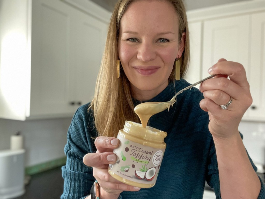 woman holding spoonful of keto coconut spread