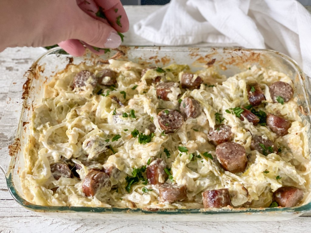 adding parsley to Keto Sausage Alfredo with Cabbage