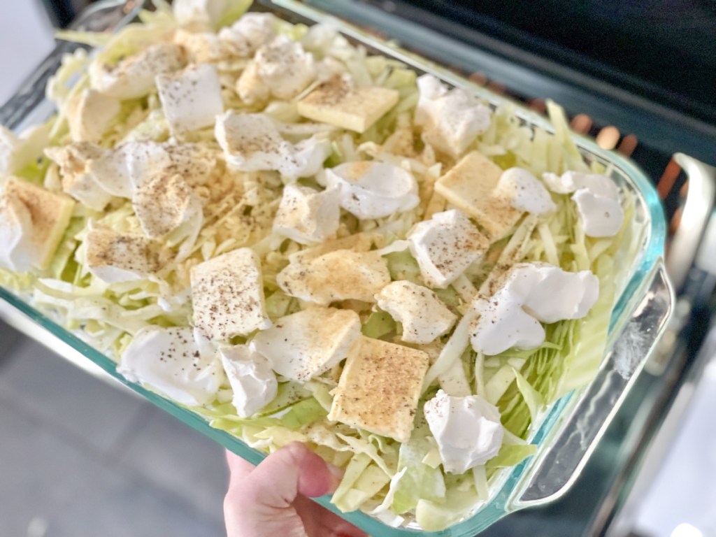placing Keto Sausage Alfredo with Cabbage in the oven