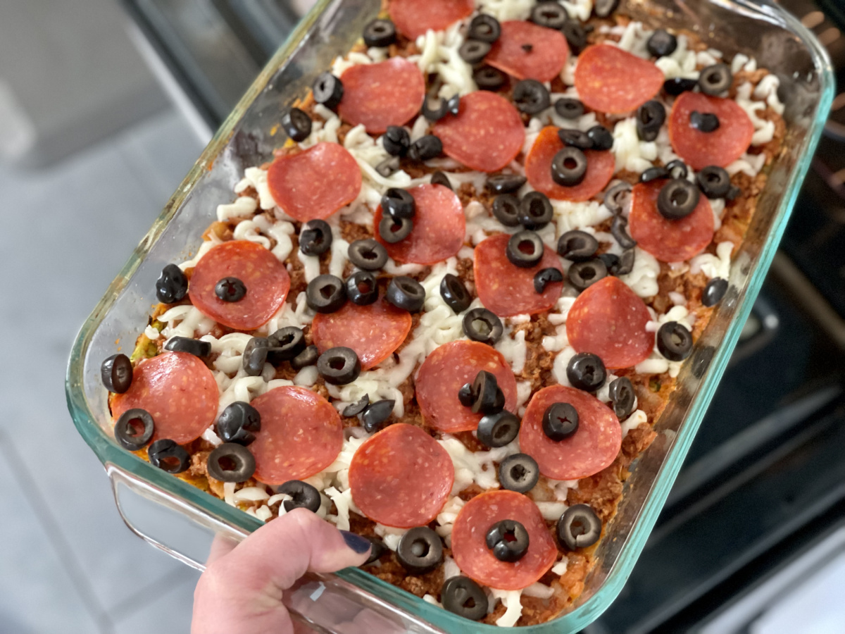 putting a keto zucchini pizza casserole bake into the oven