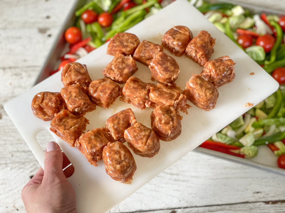 raw cut up Italian sausage on a cutting board