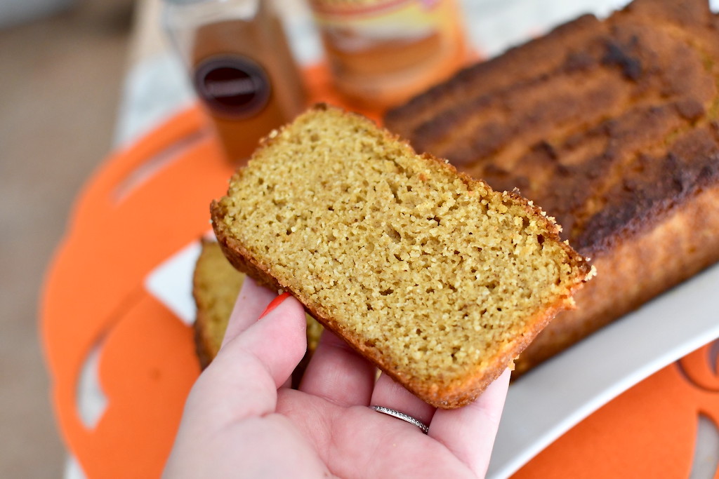 woman holding slice of keto pumpkin bread 