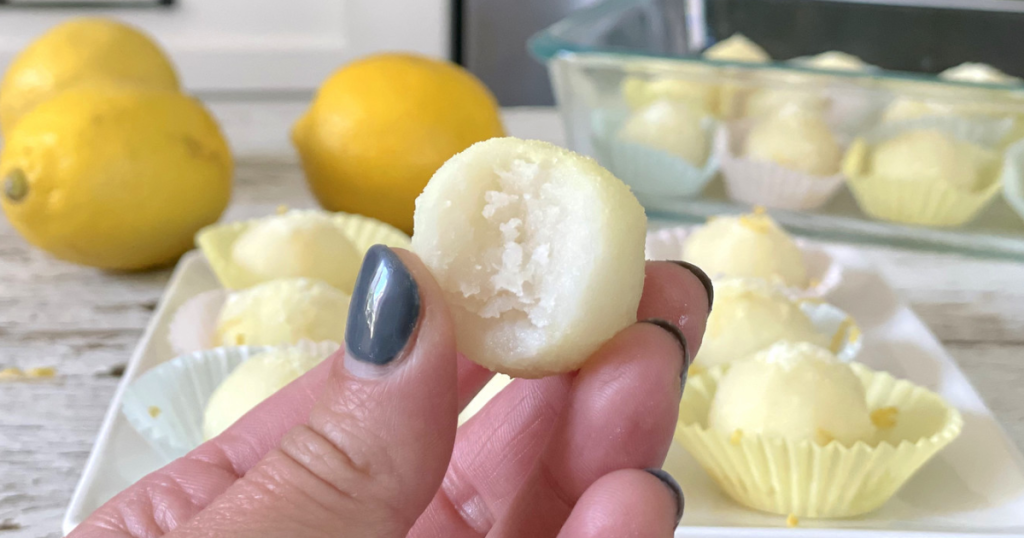 holding half-half-eatin keto lemon fat bomb 