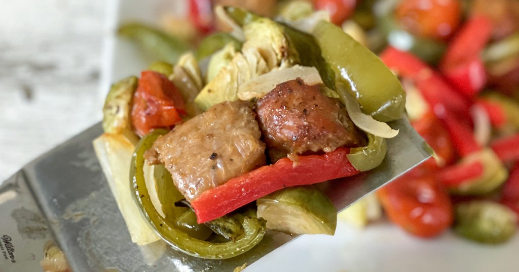 spatula of keto sausage and peppers sheet pan