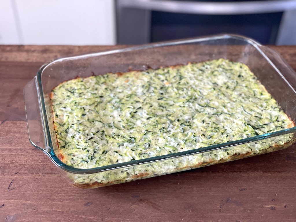 baked keto zucchini crust in casserole dish 