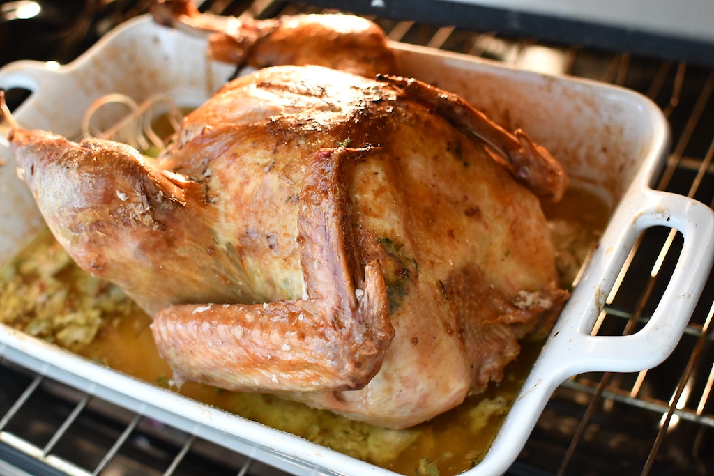 roasted turkey in casserole dish with juices