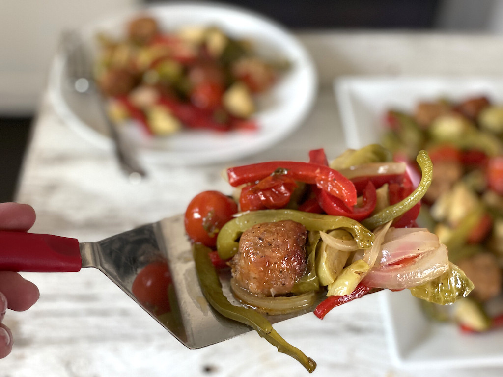 sausage and onions on spatula 