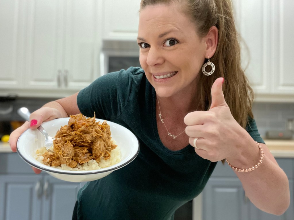 keto crockpot bourbon chicken, woman holding a plate 