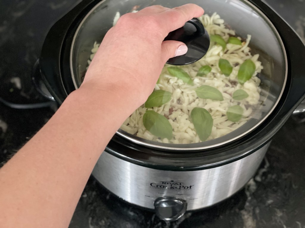 placing the lid on slow cooker low-carb lasagna