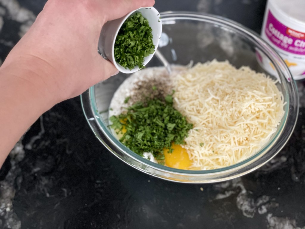 adding herbs to cottage cheese layer for slow cooker low-carb lasagna