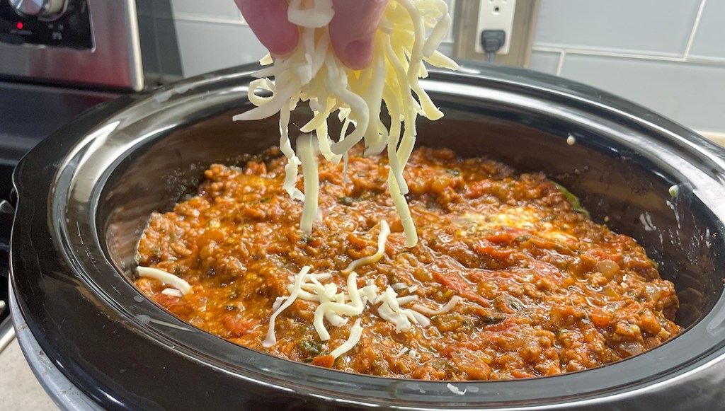 adding shredded mozzarella cheese to crockpot