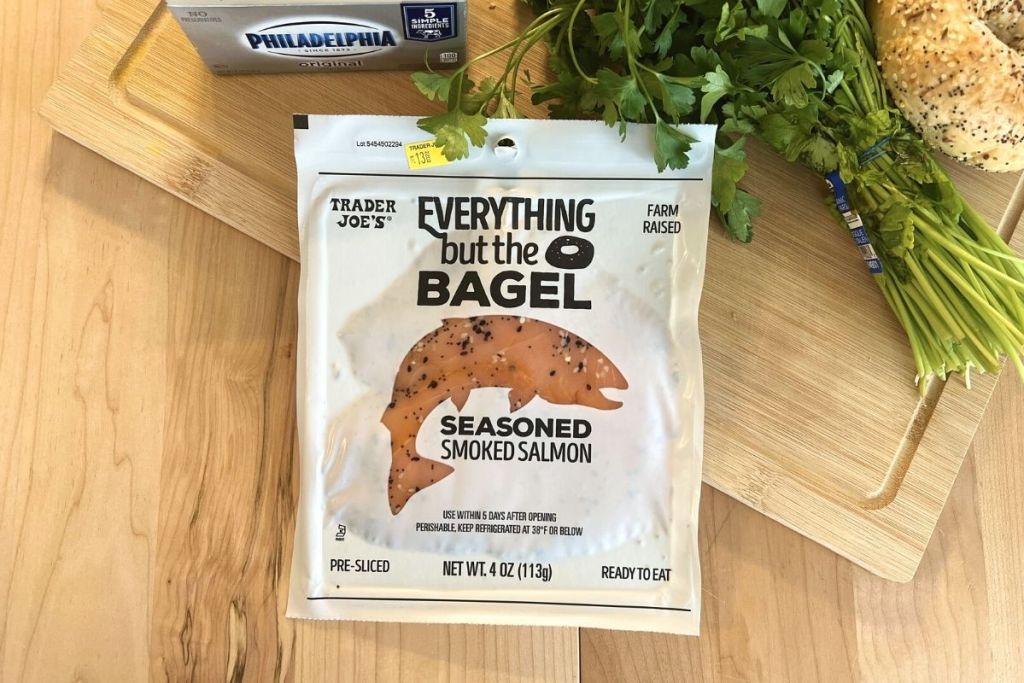 Trader Joe's Everything but the Bagel salmon on cutting board with cream cheese, parsley, and a bagel