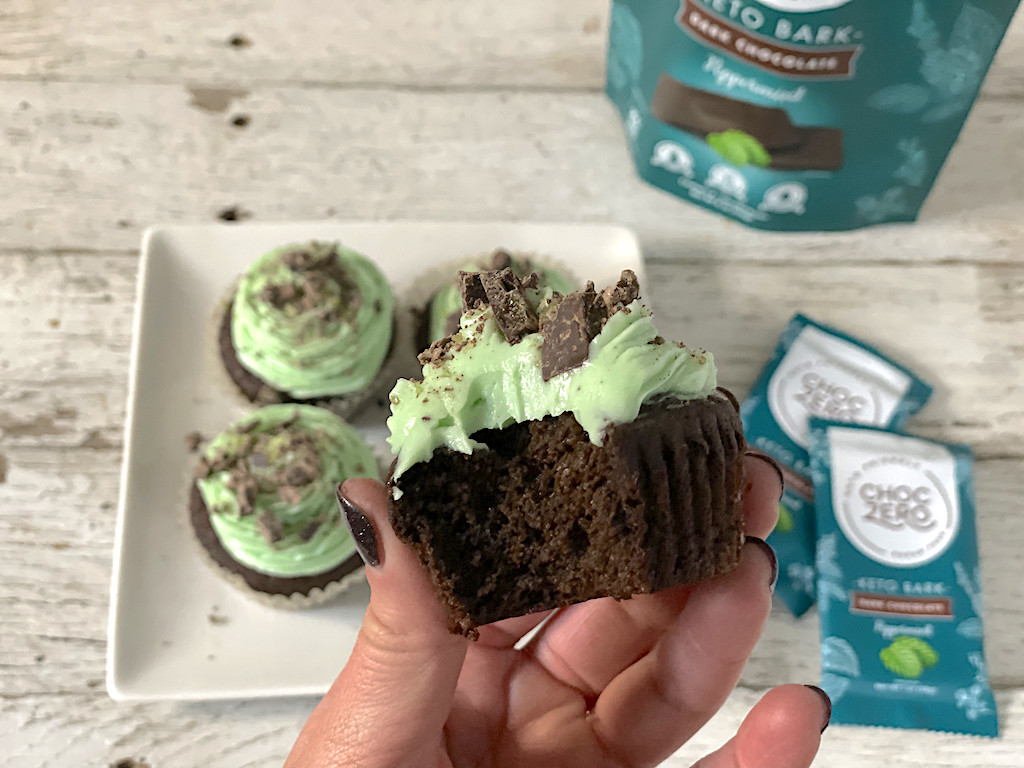 holding keto mint chocolate cupcake with bite taken 