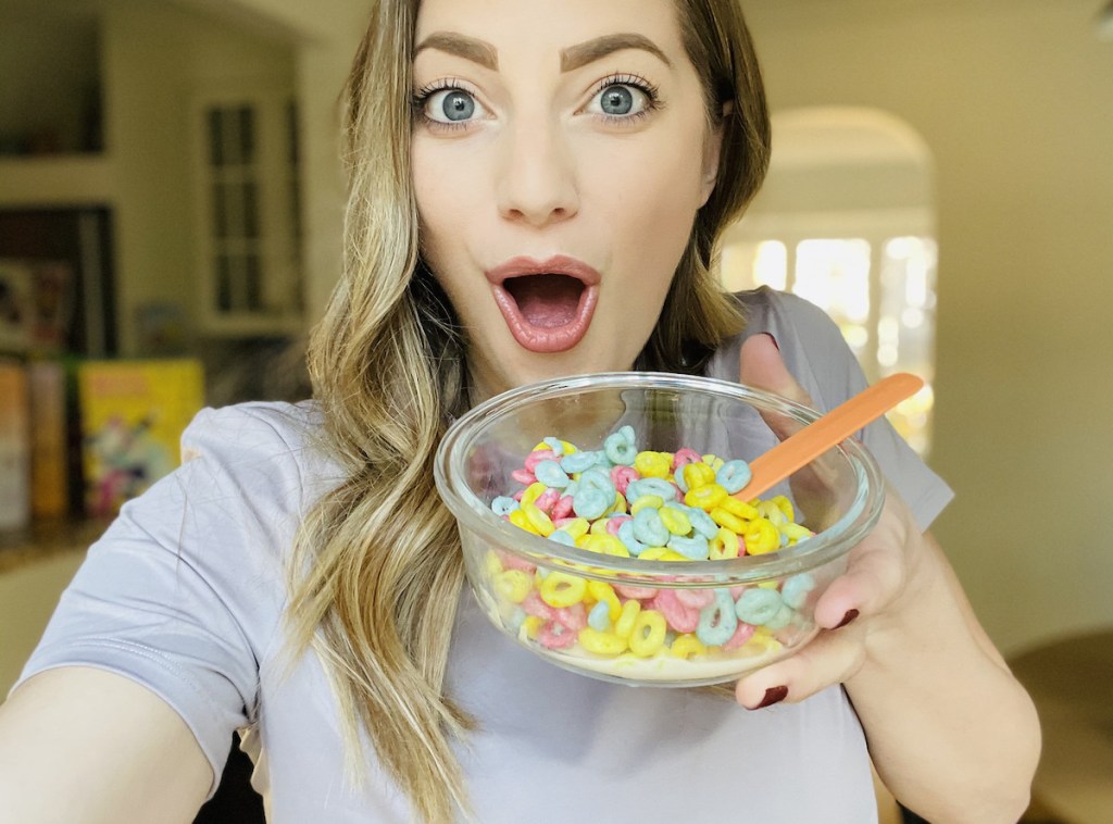 woman holding a bowl of colorful keto cereal