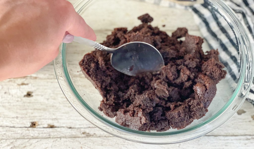 mashing up cooked brownies