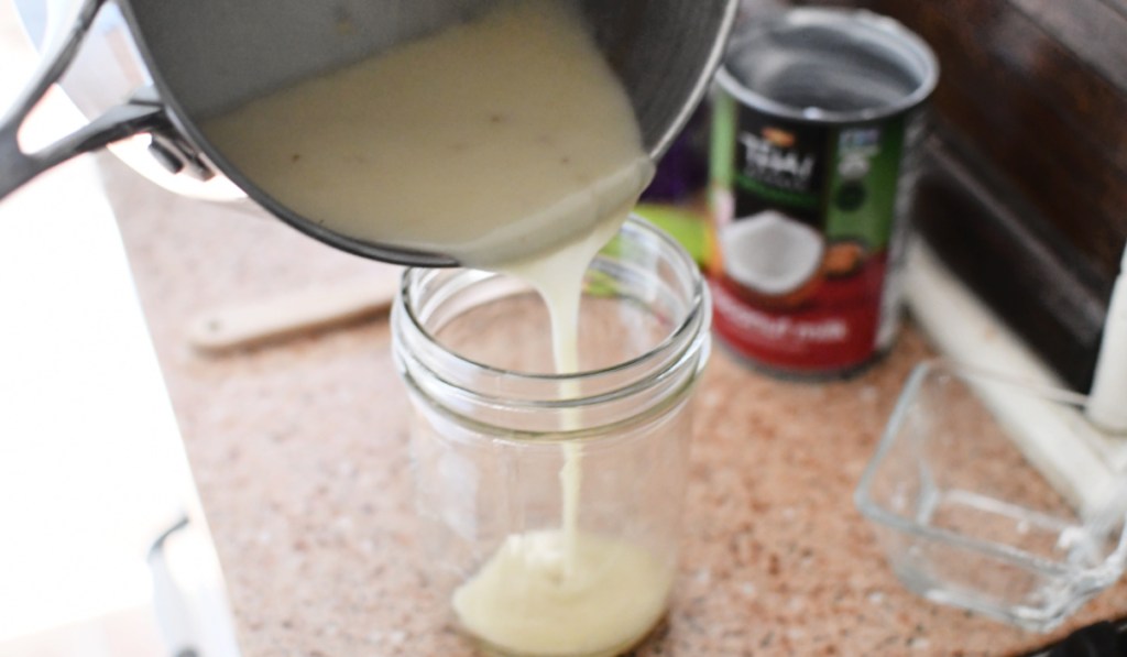 pouring keto condensed milk in a jar