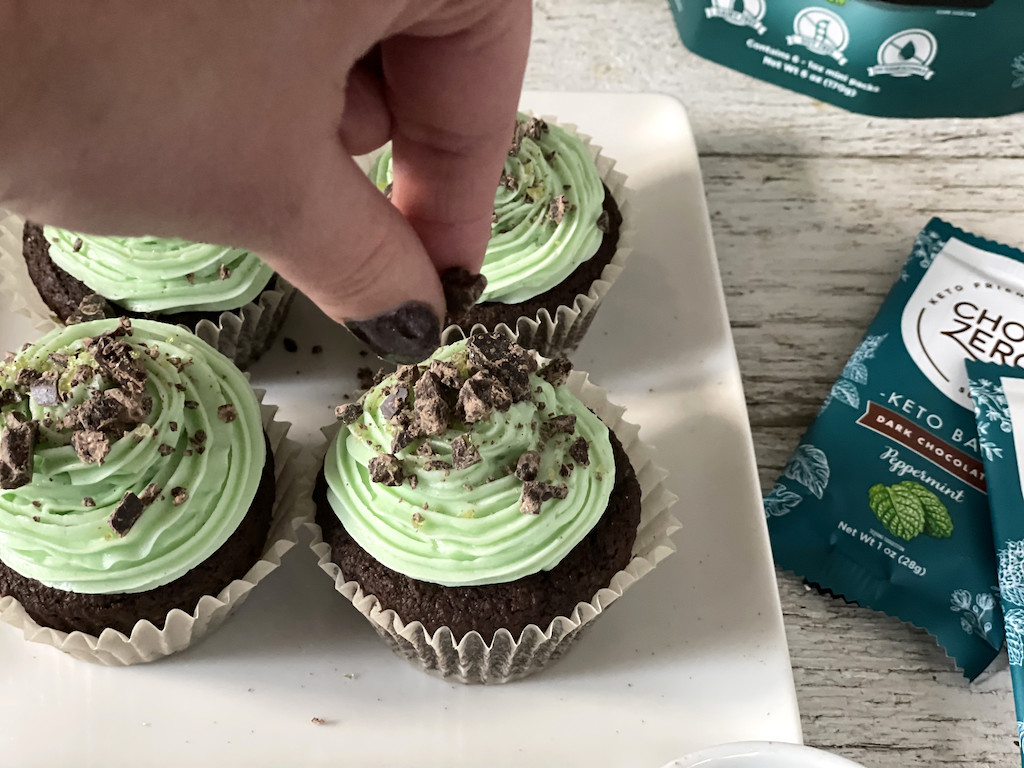 sprinkling keto cupcakes with mint chocolate chips 