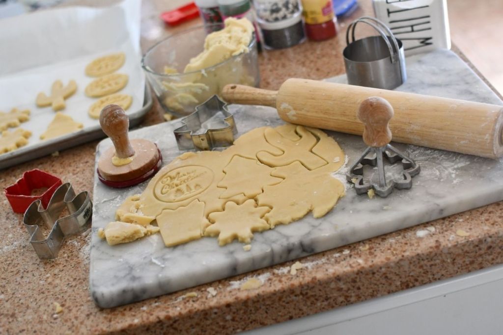 keto sugar cookie dough on counter with cut-out cookie shapes