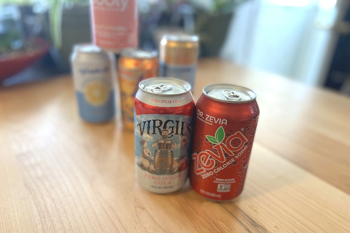 Virgil's and Zevia cans on table in front of other keto sodas and sparkling waters