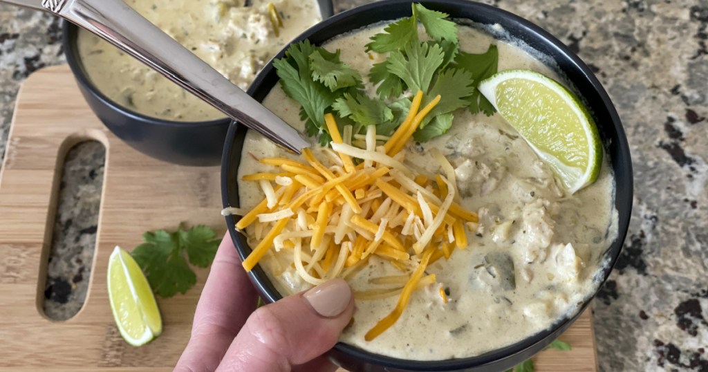 holding a bowl of Cream Cheese Chicken Chili