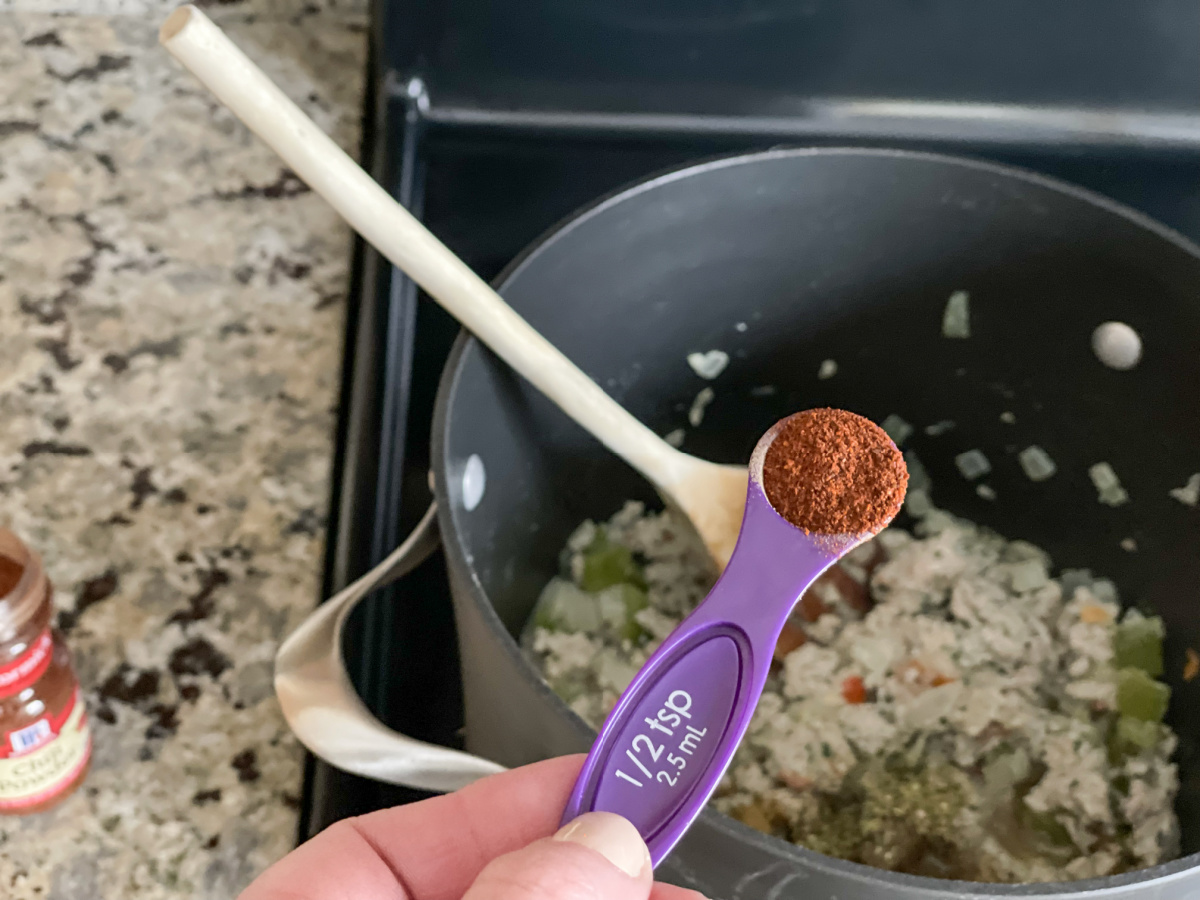 adding seasonings to stockpot 