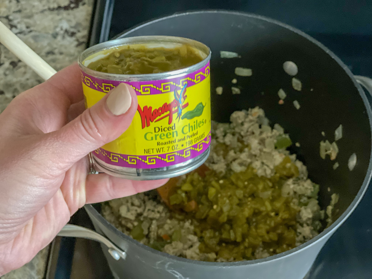 adding green chiles to stockpot