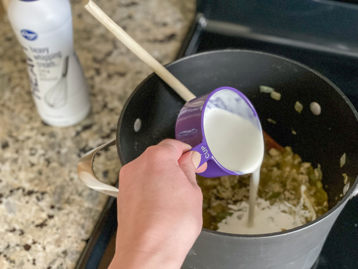 adding cream to pan