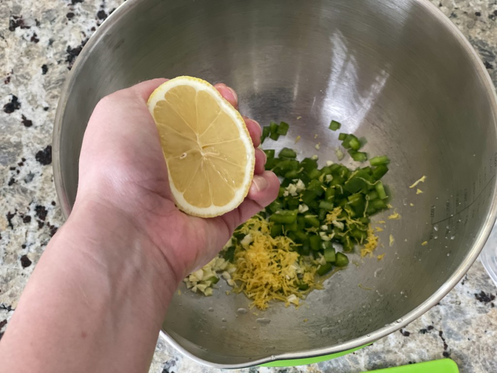 hand squeezing lemon juice into bowl