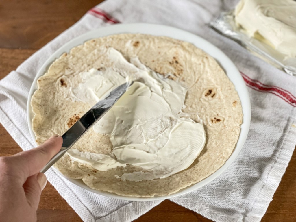 spreading cream cheese