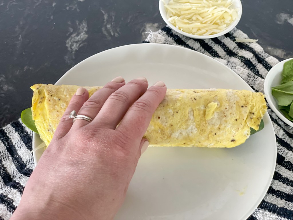 rolling up keto breakfast burrito