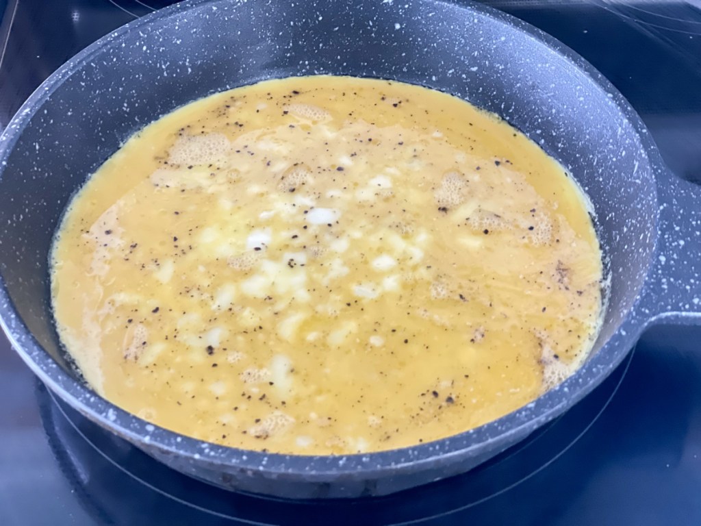eggs cooking in a skillet 