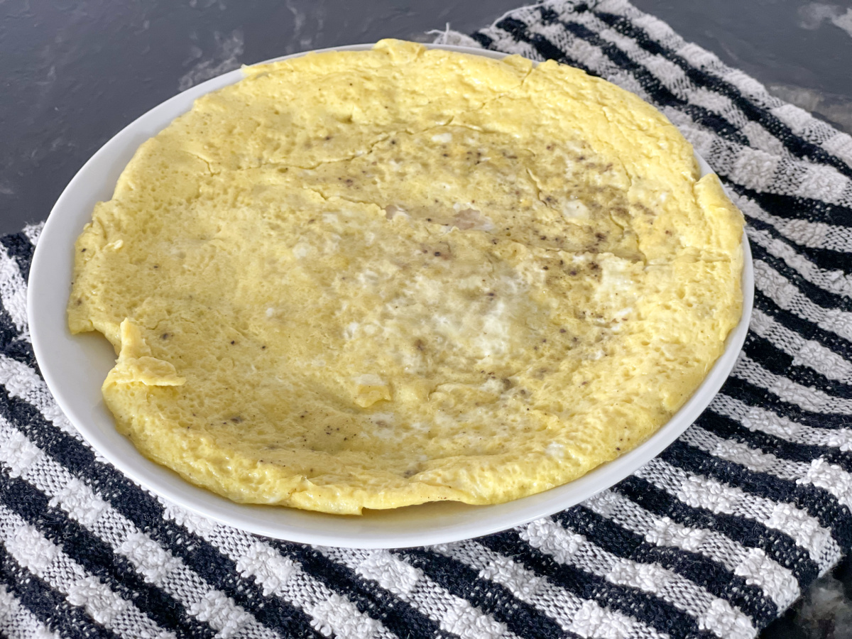 eggs cooked with a tortilla on a plate for keto breakfast burrito hack