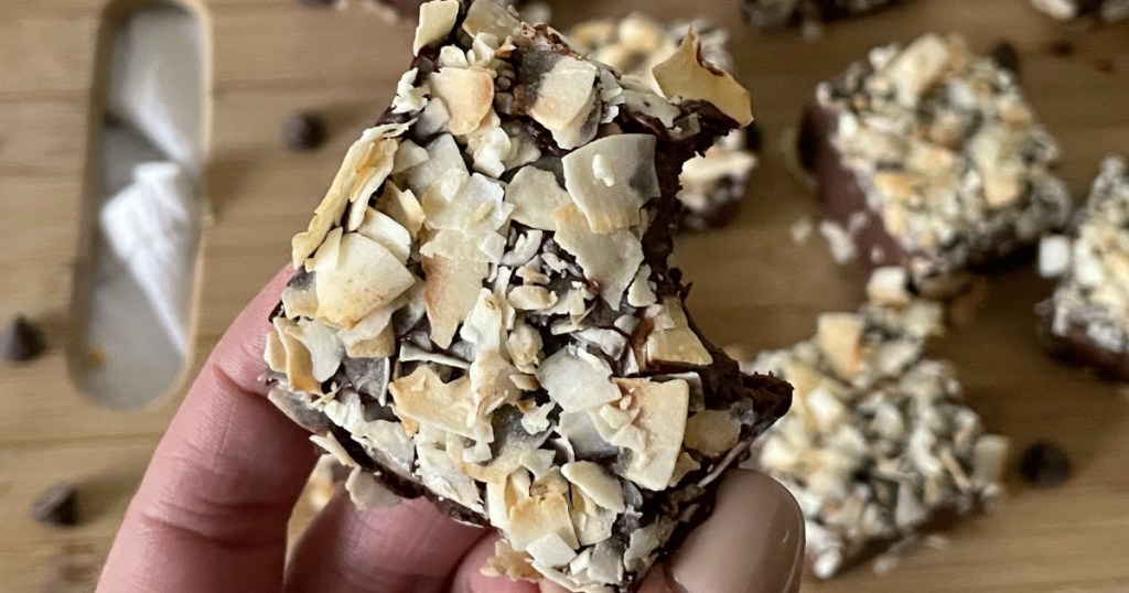 holding a piece of keto coconut fudge 